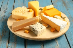 cheese, cheddar, mozzarella, parmesan, gouda, brie, camembert, manchego, gruyère, asiago, provolone, feta, ricotta, cottage cheese, cream cheese, blue cheese, gorgonzola, roquefort, stilton, burrata, halloumi, queso blanco, queso fresco, panela, cotija, swiss cheese, emmental, taleggio, pecorino romano, mascarpone, paneer, kefalotyri, havarti, colby jack, monterey jack, mimolette, fontina, limburger, reblochon, raclette, dairy fermentation, rennet, affinage, cave-aged, raw milk, pasteurized, artisanal, cheeseboard, fondue, charcuterie